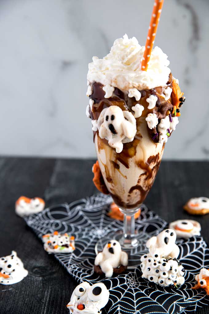 Vanilla freakyshake decorated with Halloween ghosts candy, sprinkles and jimmies.