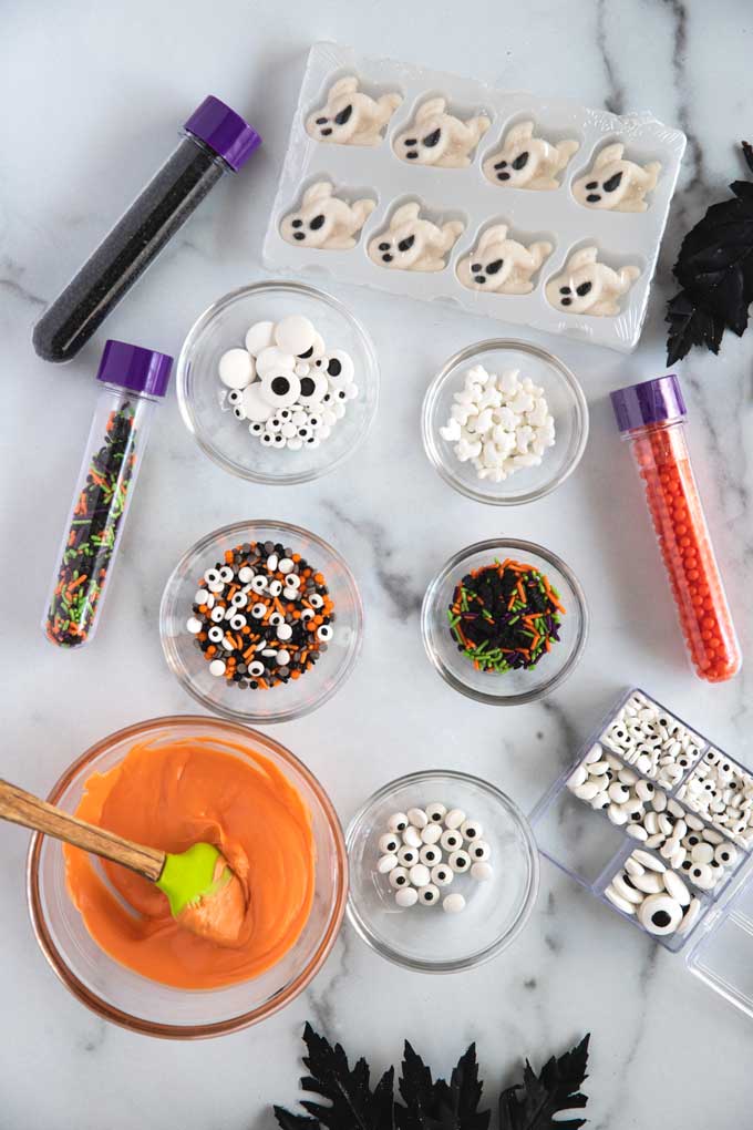 Table set up with ingredients to decorate the Halloween pretzels.