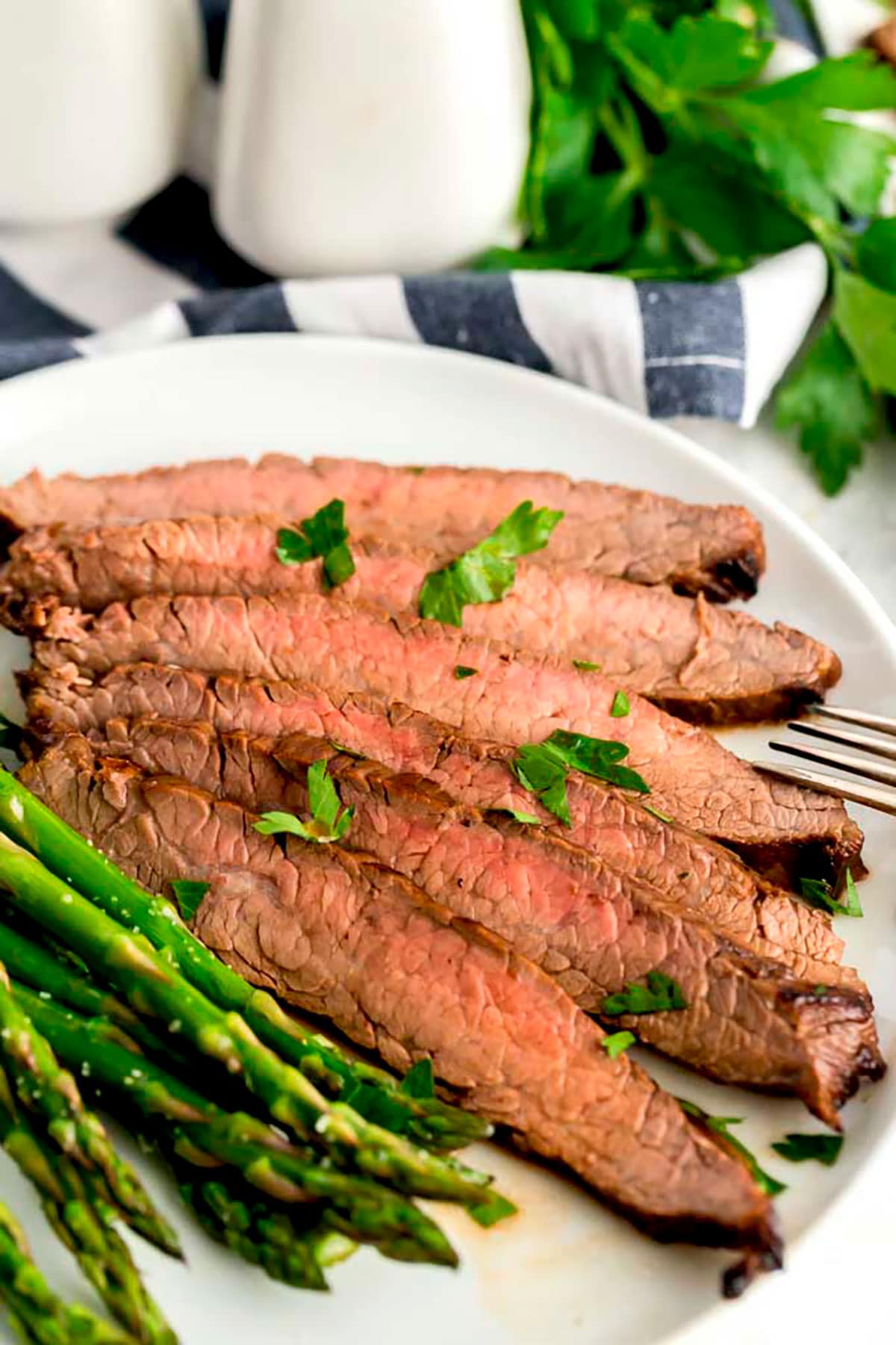 London broil gesneden en geserveerd met asperges.