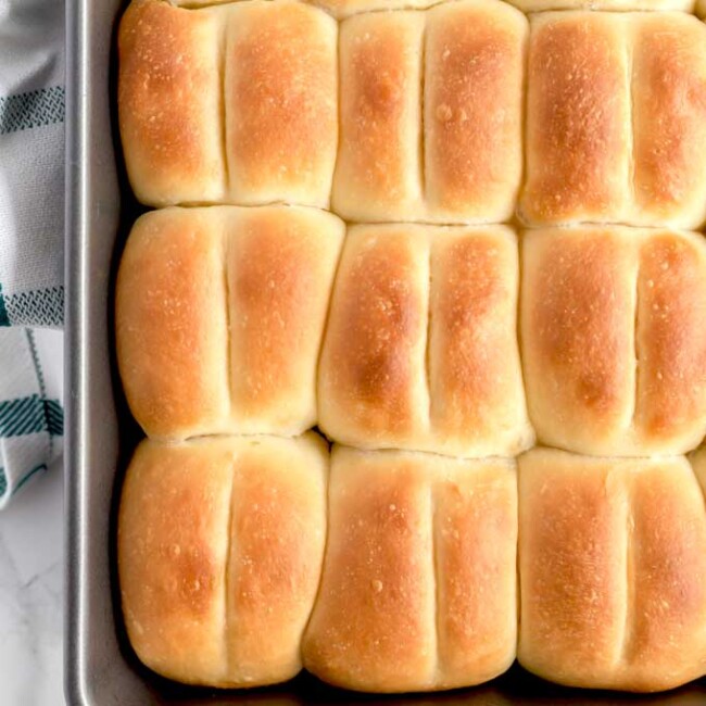 View of a baking dish filled with Parker House Rolls