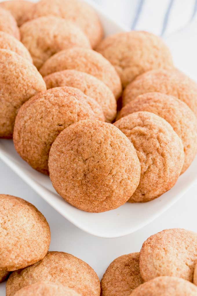 Cinnamon sugared covered cookies on a white plate.