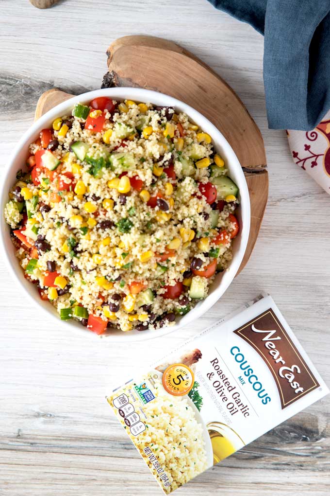 Top view of couscous salad on a white surface.