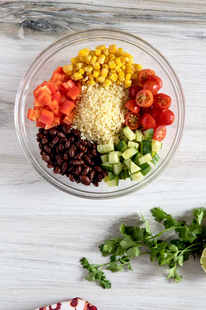 Couscous surrounded by vegetables and beans