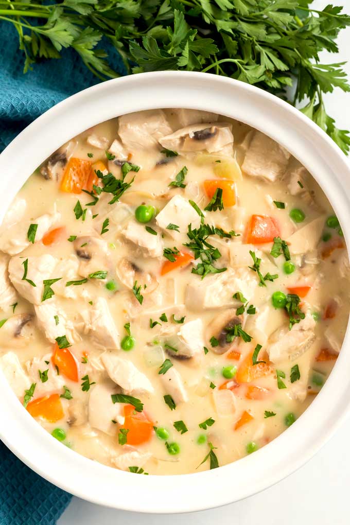 Creamy chicken and vegetables in a round white bowl