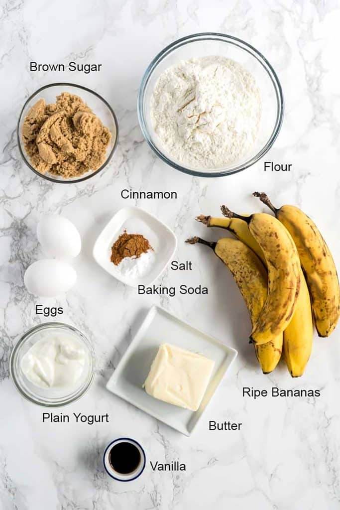 Ingredients for the banana bread over a marble surface