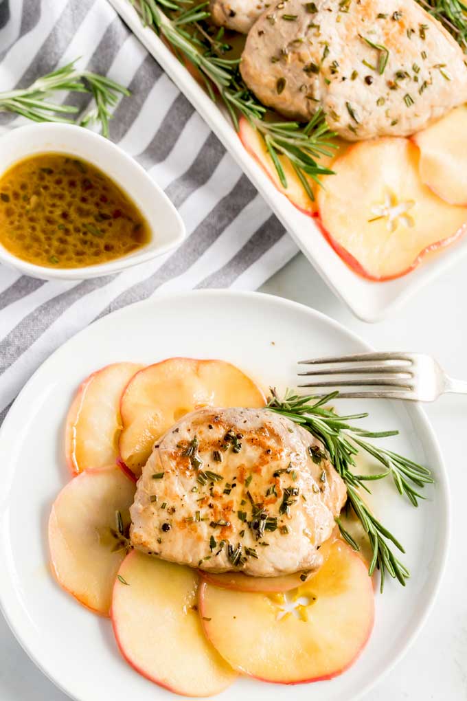 Herb crusted pork chops on a bed of saute apples