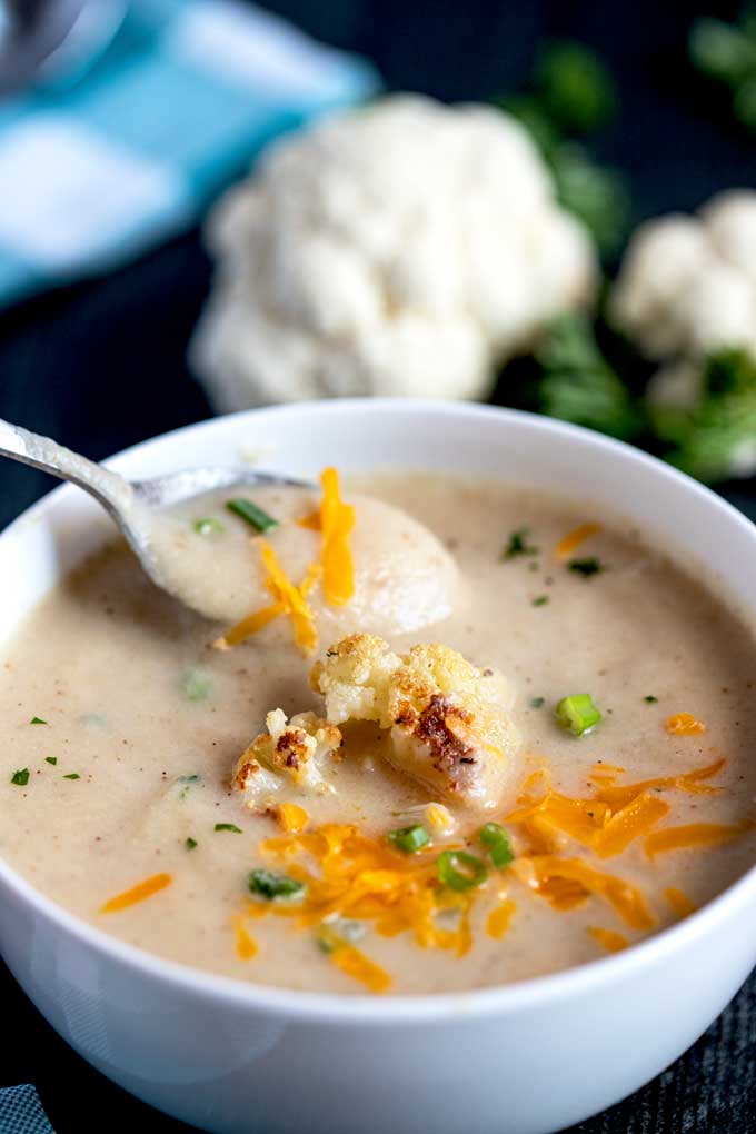 Spooning soup from a bowl.