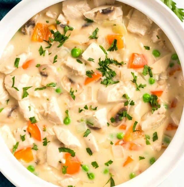 Creamy chicken and vegetables in a round white bowl