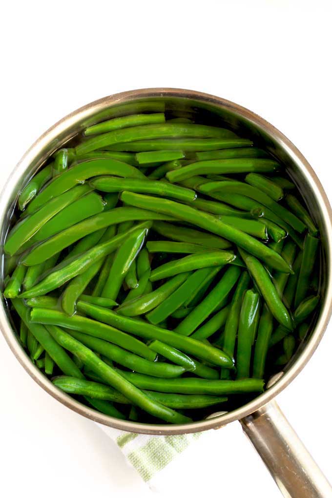 Blanched green beans or string beans in a pot of water