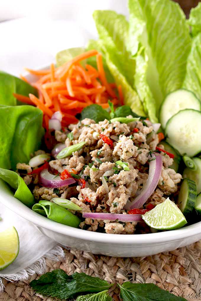 Ground chicken and fresh herbs salad served with fresh raw vegetables.