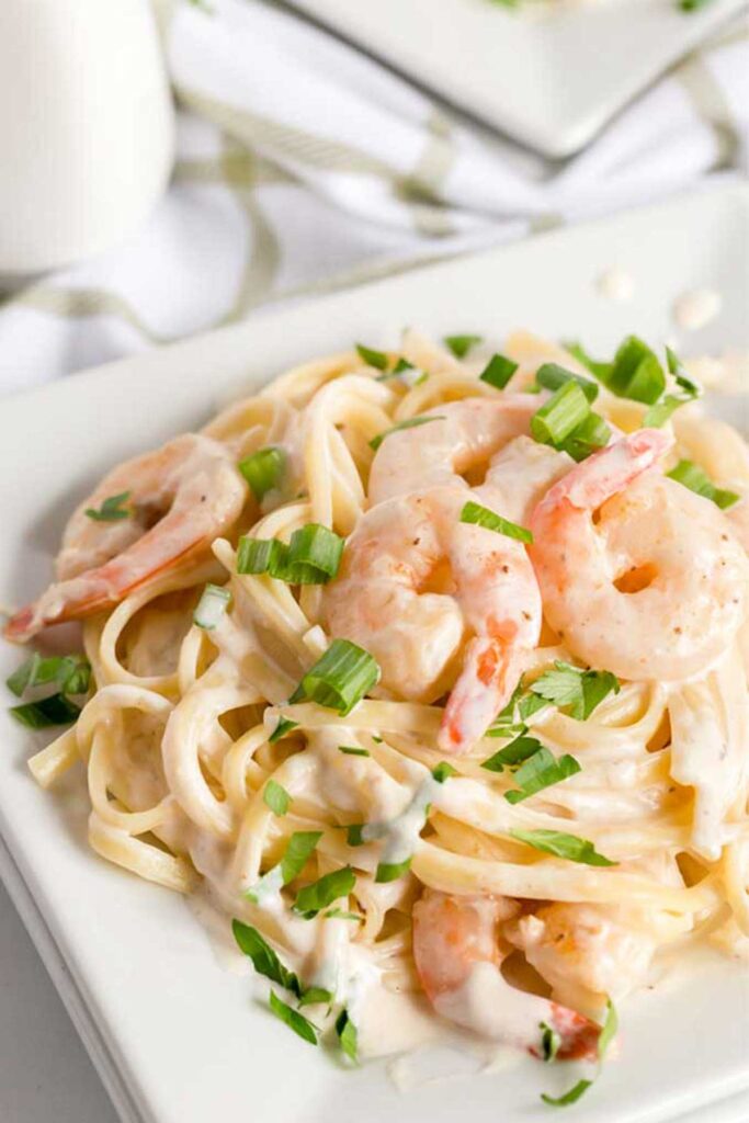A plate with Shrimp pasta in Alfredo sauce
