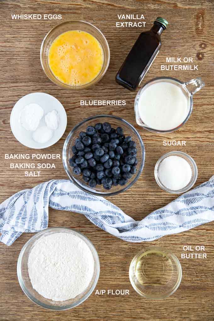 Ingredients to make this blueberry pancake recipe on a wooden table.