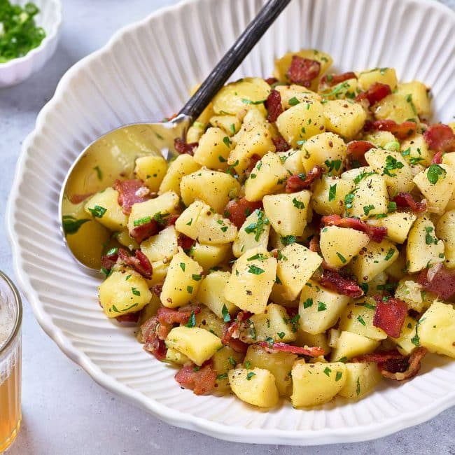 German Potato Salad in a white bowl.