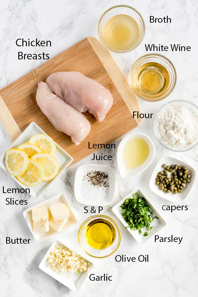 Chicken Piccata ingredients over a marbled surface