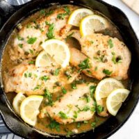 Delicious Italian Chicken Piccata with lemon slices and capers in a skillet.