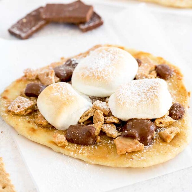 Hot off the oven s'more flatbread dessert pizza on a white surface