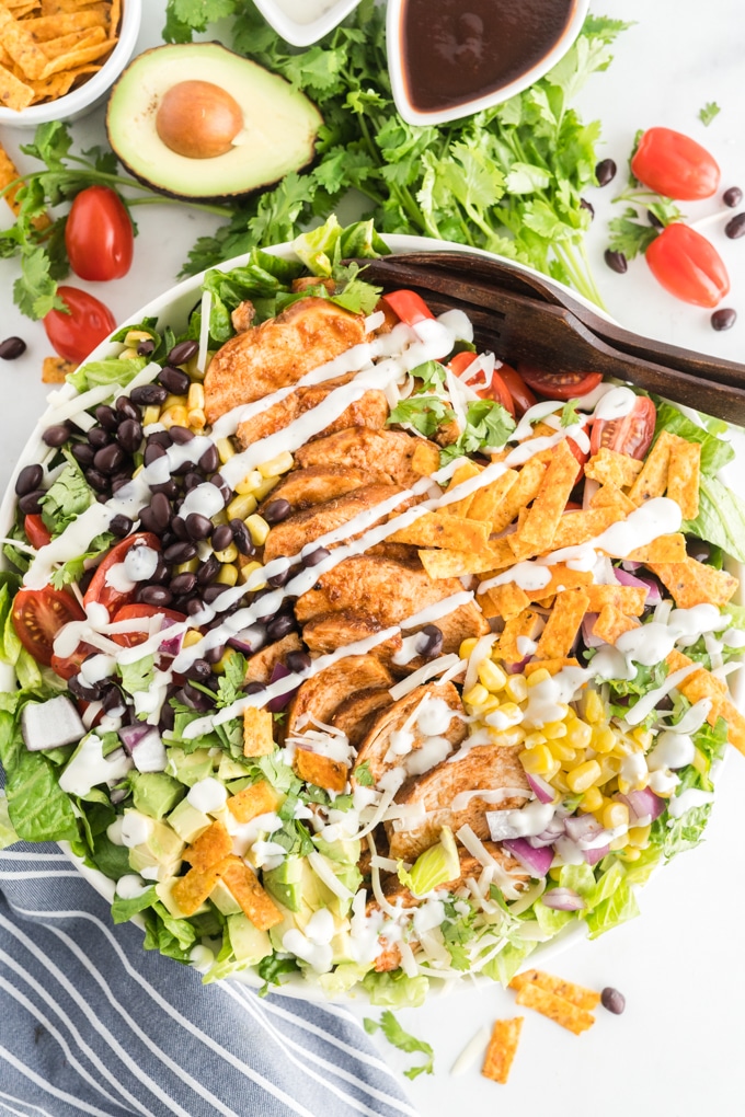 Barbecue chicken over salad with ranch dressing.