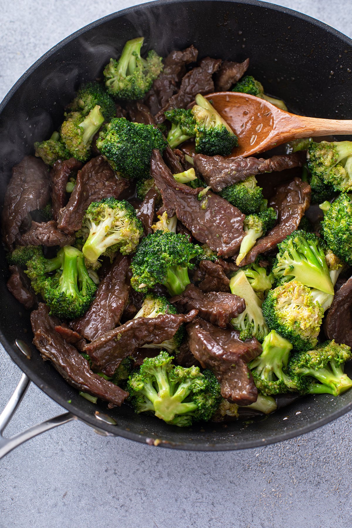 Close-up view of a skillet with beef and broccoli