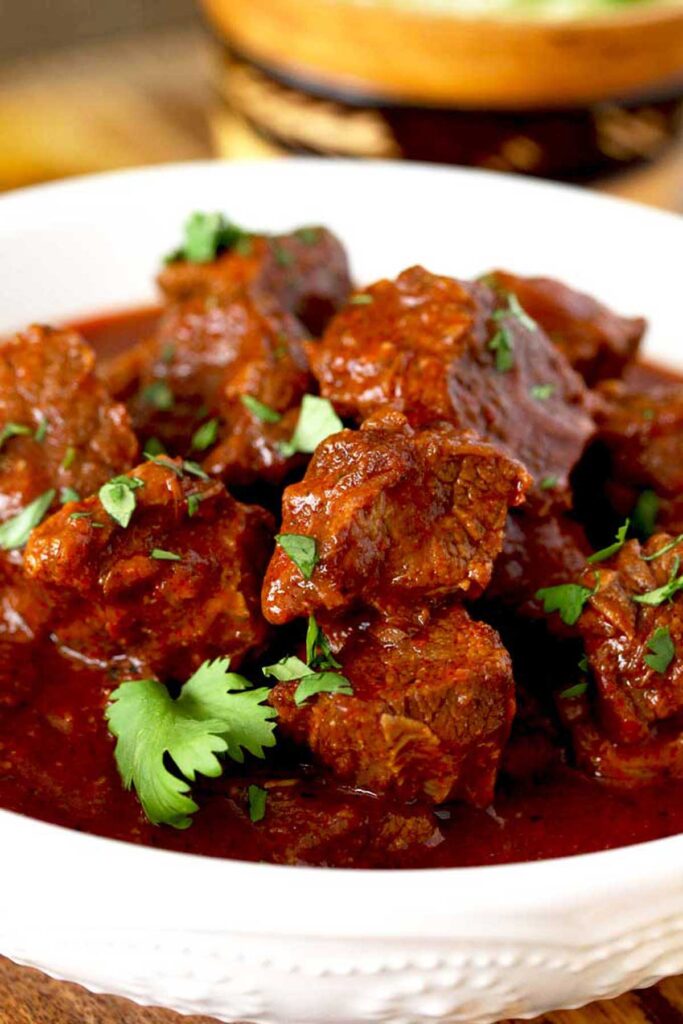 Chunks of beef covered in red sauce