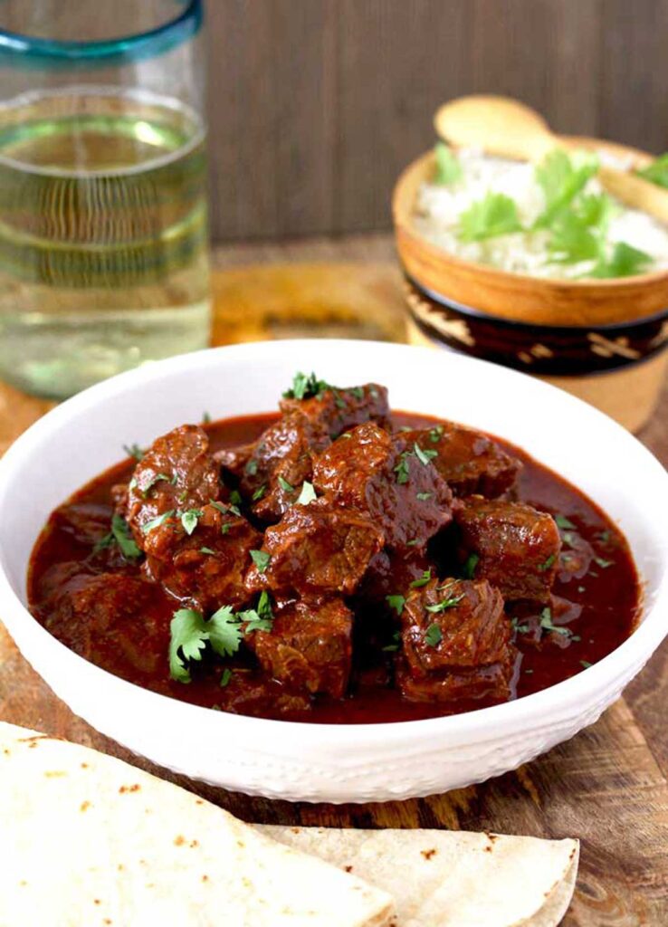 Beef chile colorado stew served in a white bowl