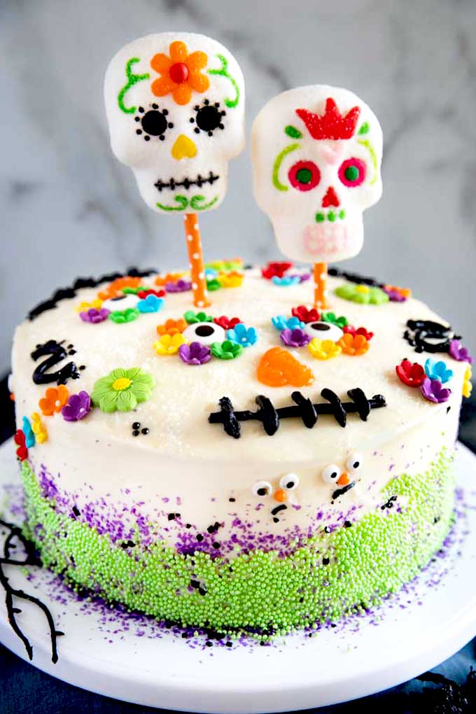 Dia De Los Muertos cake on a cake stand.