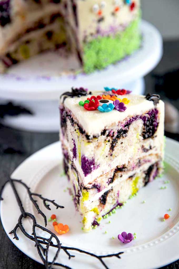 A slice of Day of Dead Cake on a white plate.