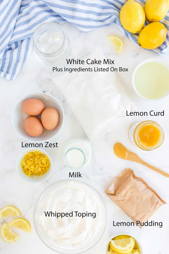 Ingredients to make Luscious Lemon Cake on a white surface