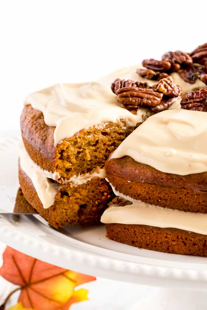 Serving a slice of pumpkin spice cake from a cake platter