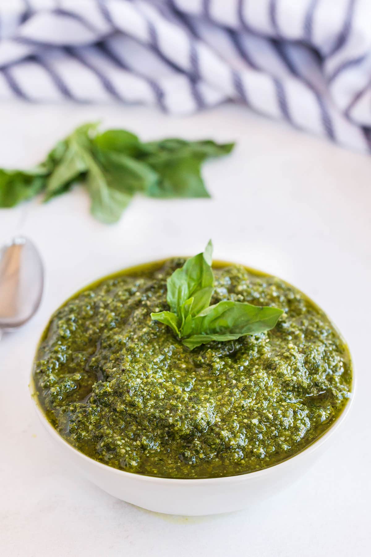 A white bowl filled with pesto made from scratch.