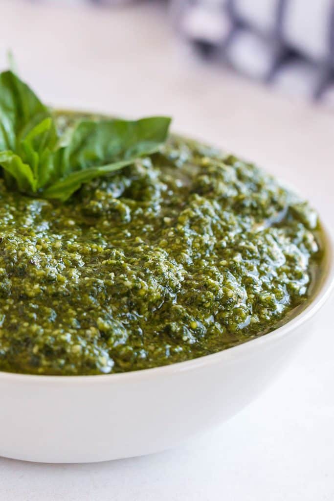 Close up of a white bowl filled with Italian pesto.