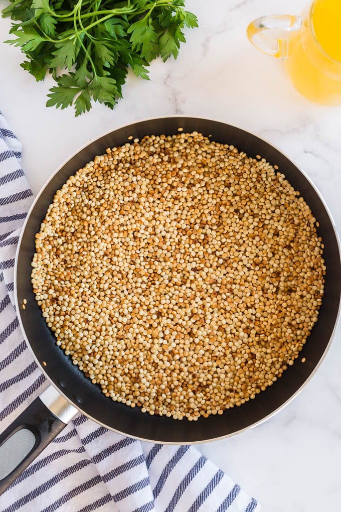Toasting pearled couscous in a skillet