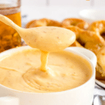 Pin image of beer cheese dip in a white bowl