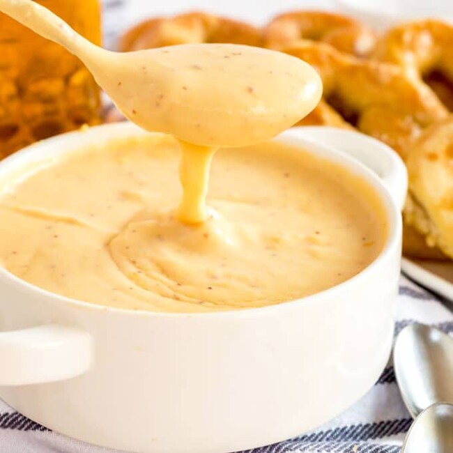 cheese dip scooped from a white bowl