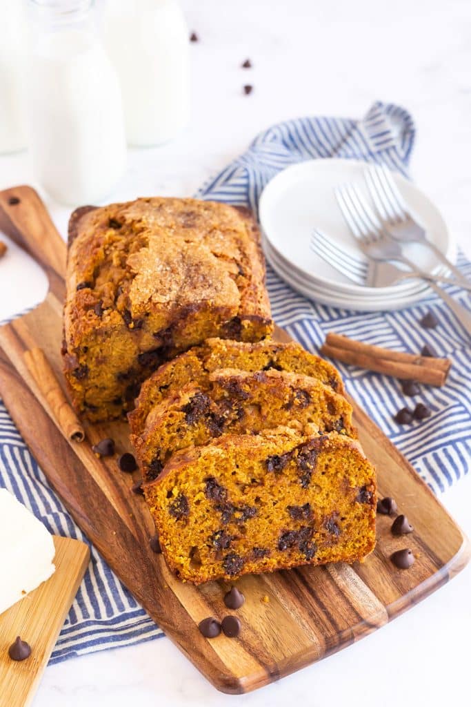 Chocolate Chip pumpkin loaf sliced over a wooden board.