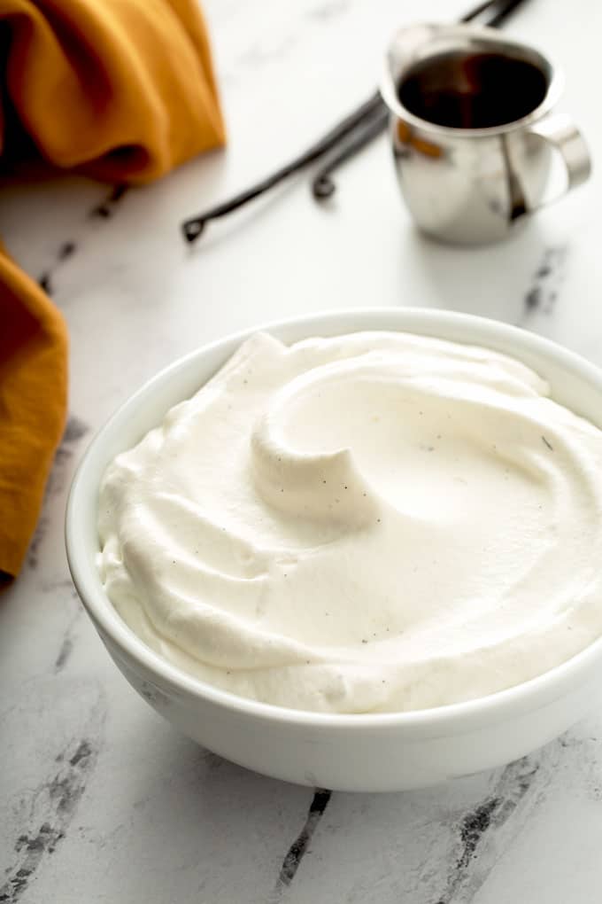 Light and fluffy maple whipped cream in a white bowl.