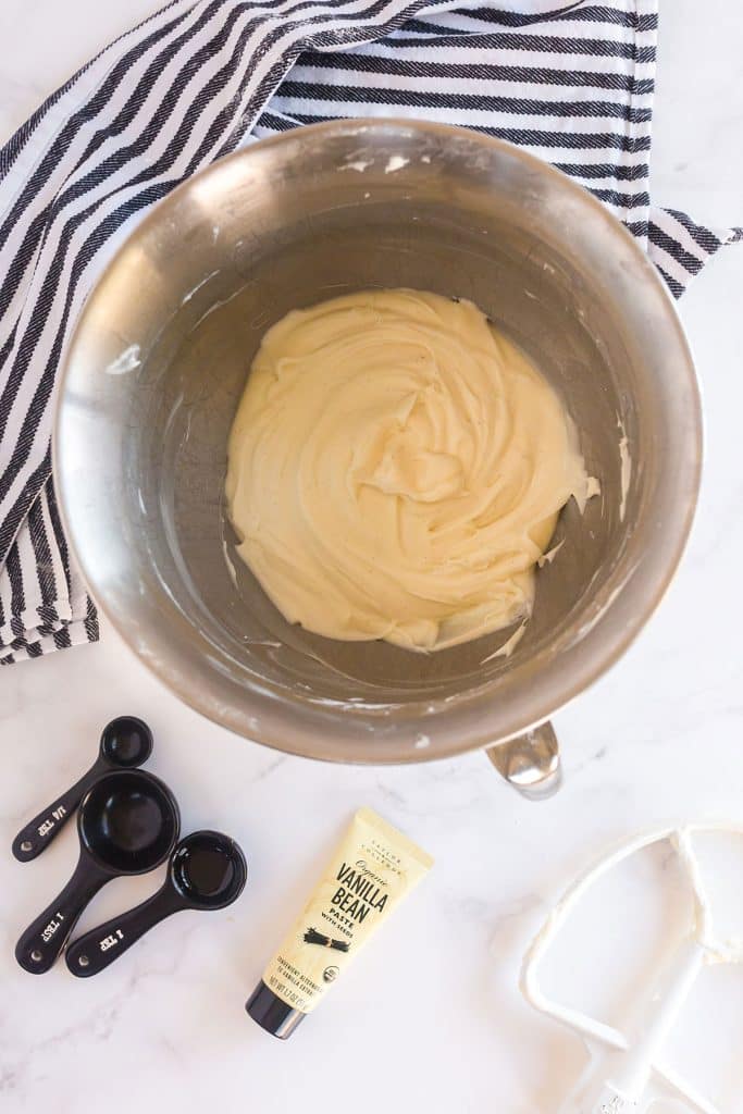 cream cheese frosting in the bowl of a standing mixer