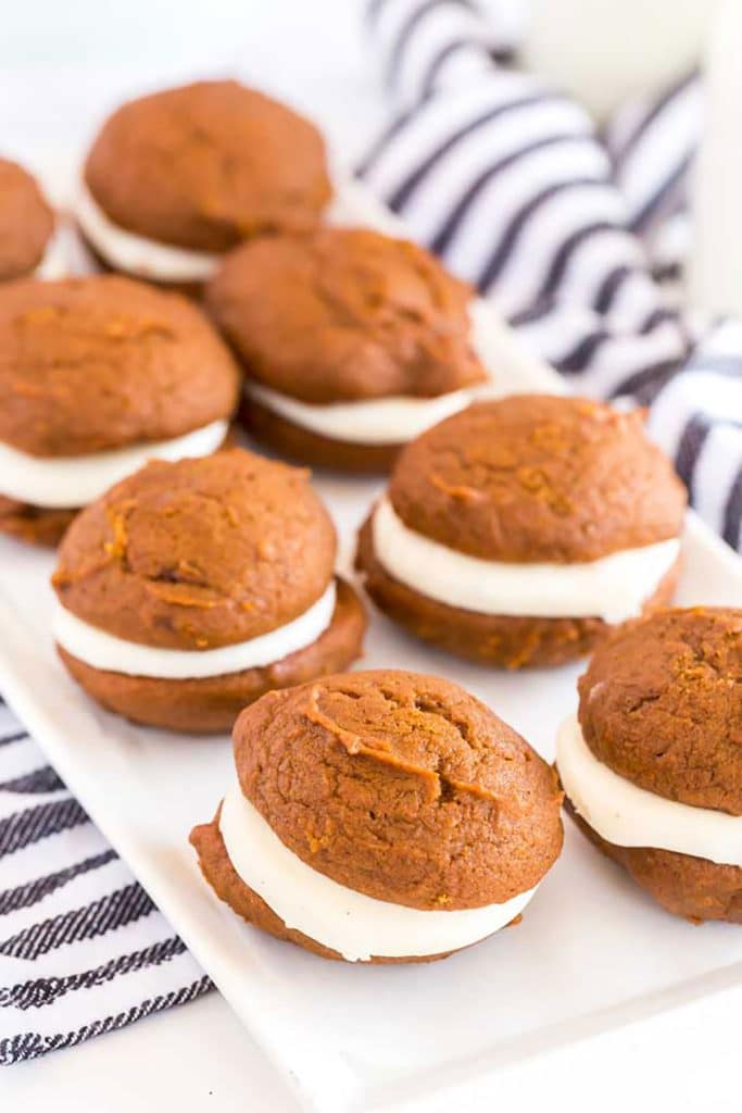 Eight homemade whoopie cookies on a white dish