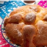 Pin image of a loaf of Mexican Pan de Muerto bread