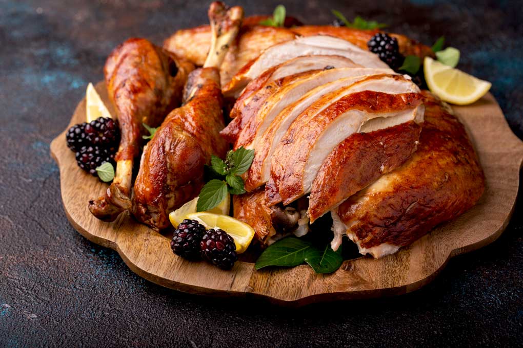 Roast Turkey cut up and sliced on a wooden platter