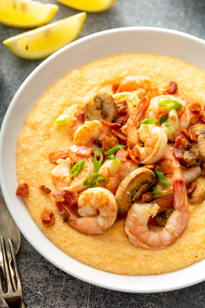 top view of Bowls filled with cheesy grits and topped with shrimp