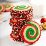 A stack of Christmas cookies on a white surface