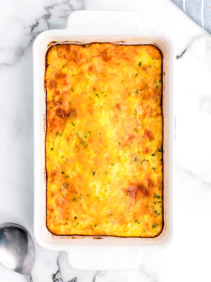 top view of baked corn pudding in a baking dish