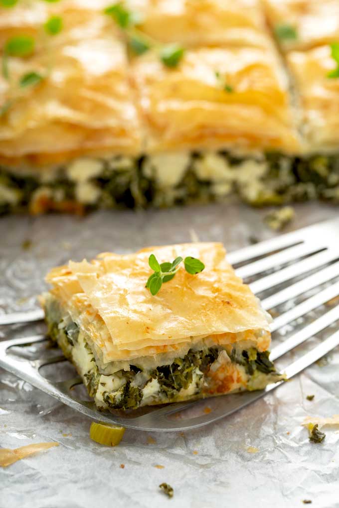 A serving of spinach pie on a spatula.