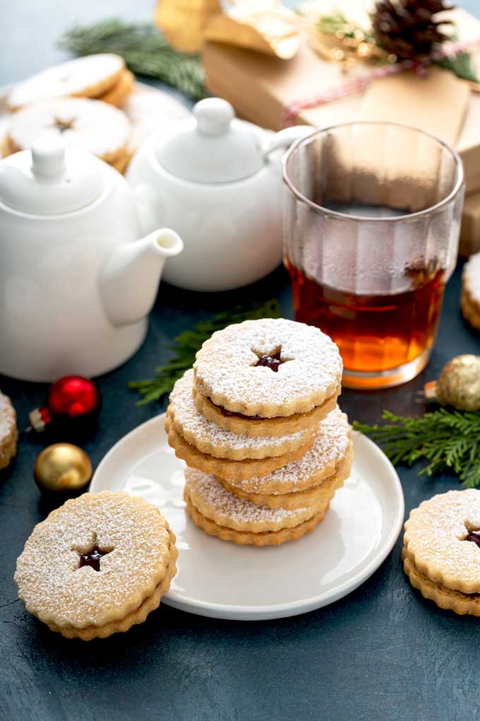 Linzer cookies stack on a white plate