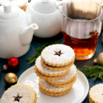 A stack of Linzer cookies on a white plate