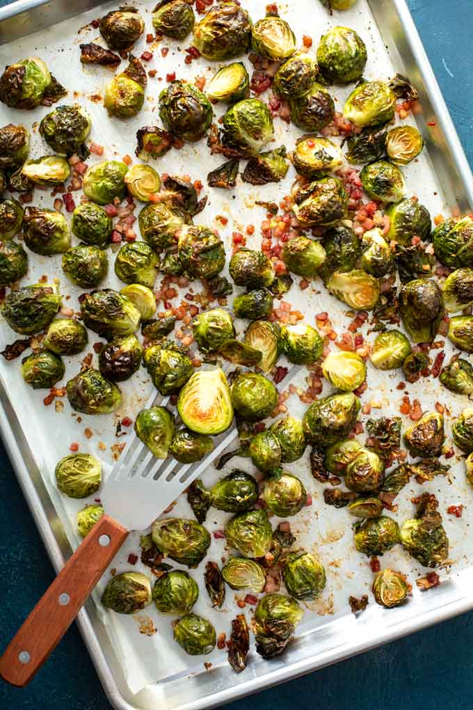 Golden Brussels sprouts and bacon on a sheet pan.