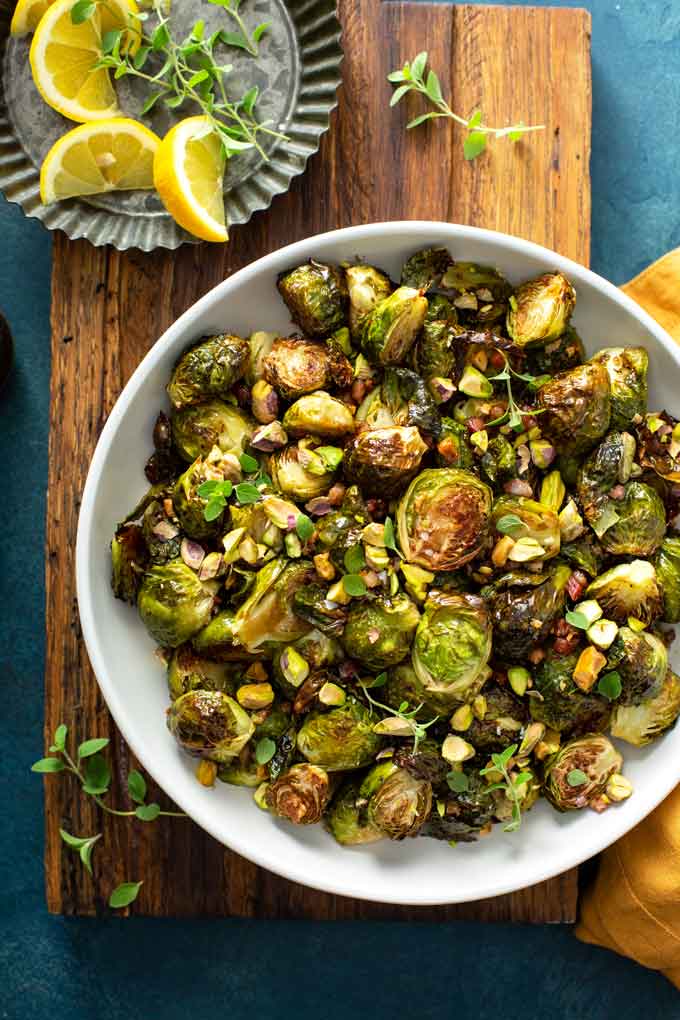 A white bowl filled with Balsamic Brussels sprouts with bacon.