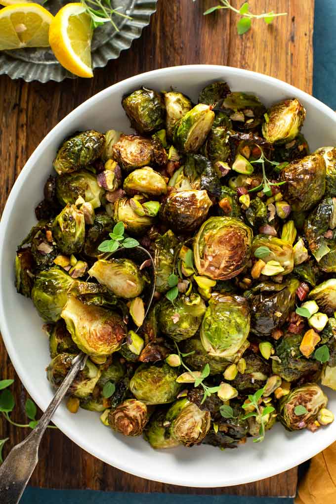 A white bowl filled with roasted Brussels sprouts.