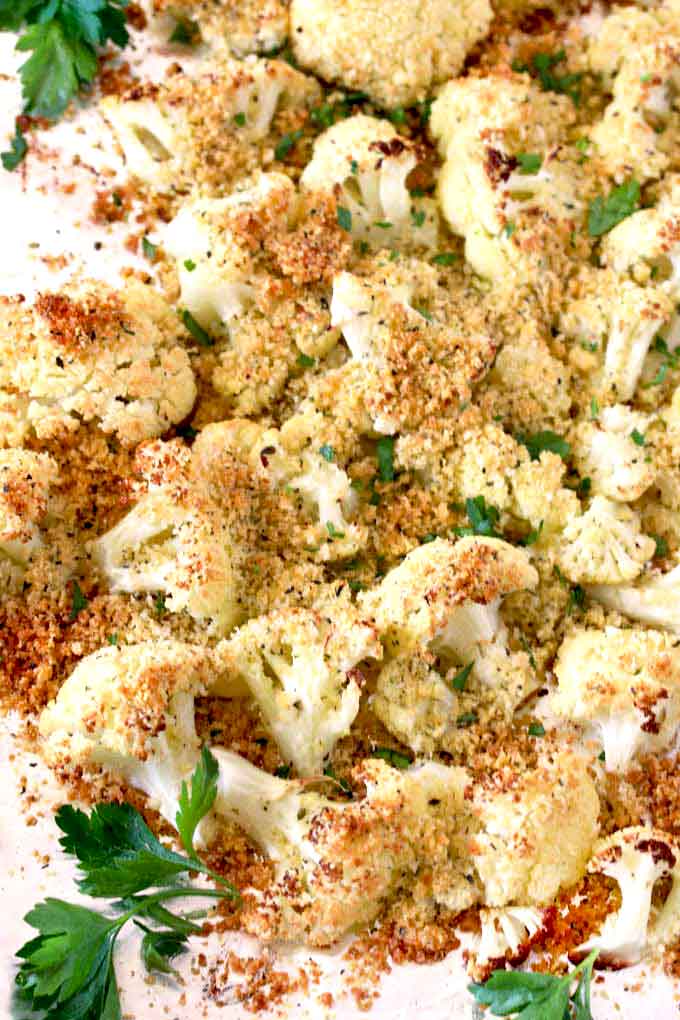 Golden brown roasted cauliflower with Parmesan on a sheet pan