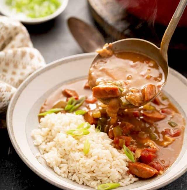 Serving Cajun gumbo with a ladle.